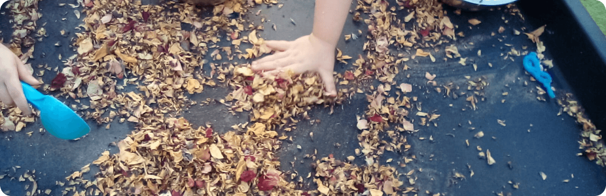 A child playing with leaves